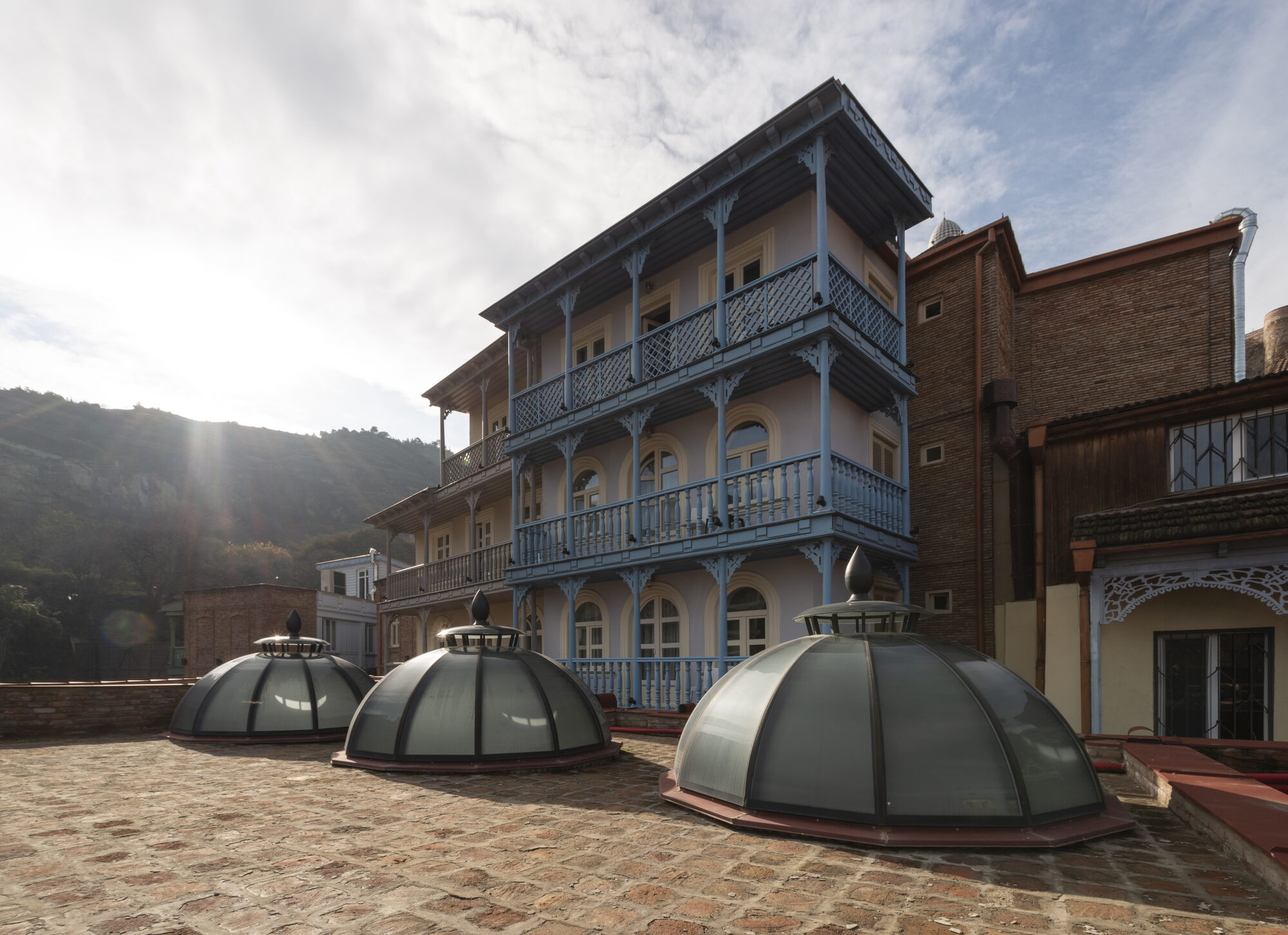 Glazed skylight domes of Chreli Abano with historic balconies behind